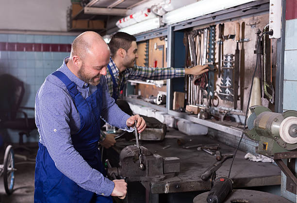 istock Mechanics at work in repair shop 493194712