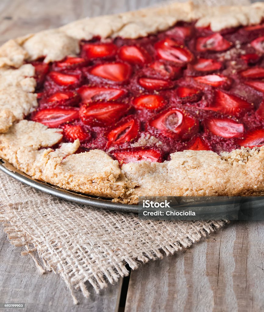 Wholegrain tart with strawberry Wholegrain tart with strawberry on the wooden table close-up Baked Stock Photo