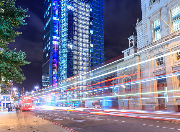 istock London, double-decker bus passing at financial district 493200361