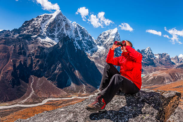 istock Woman looking through binoculars in Mount Everest National Park 493202177