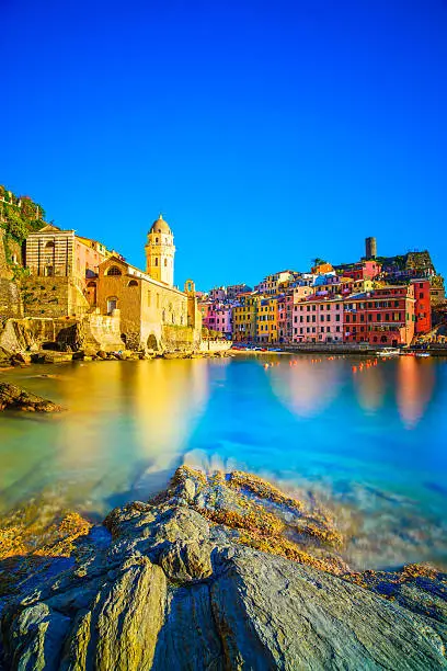 Vernazza village, church, rocks and sea harbor on sunset, Seascape in Five lands, Cinque Terre National Park, Liguria Italy Europe. Long Exposure.