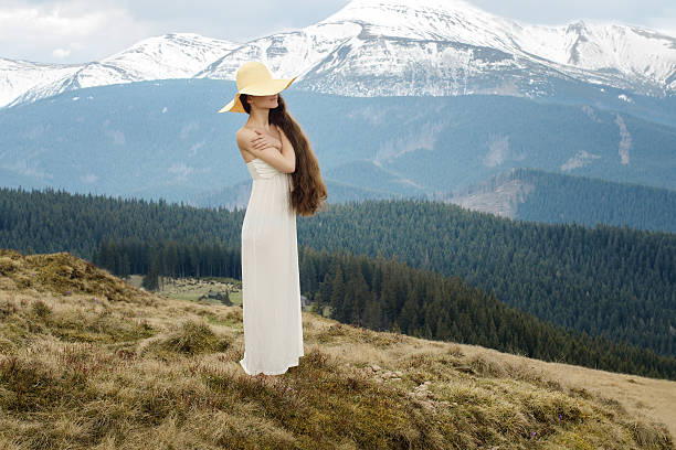 istock Young woman standing on a hillside in the mountains 493203791