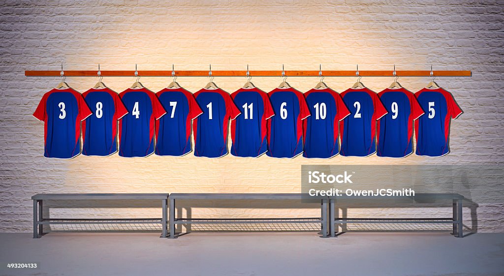 Row of Football Team Shirts Row of Blue and Red Football Shirts in Locker Room Locker Room Stock Photo
