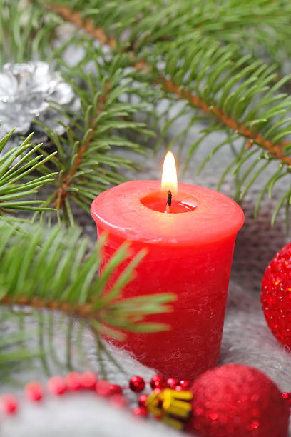 istock Red candle with christmas decoration 493209136