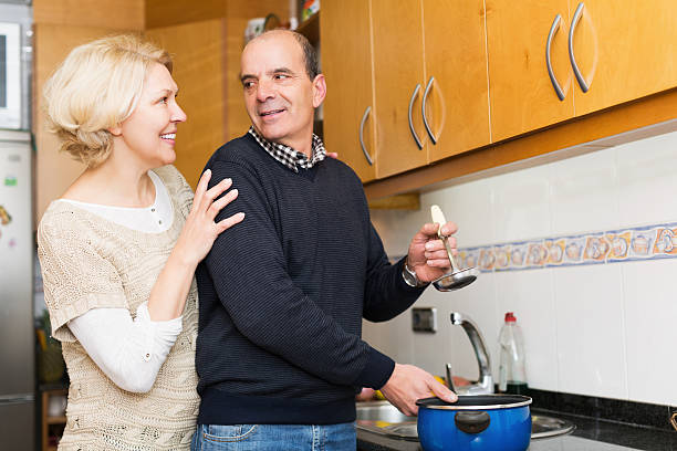 istock Husband helping wife to cook 493209690