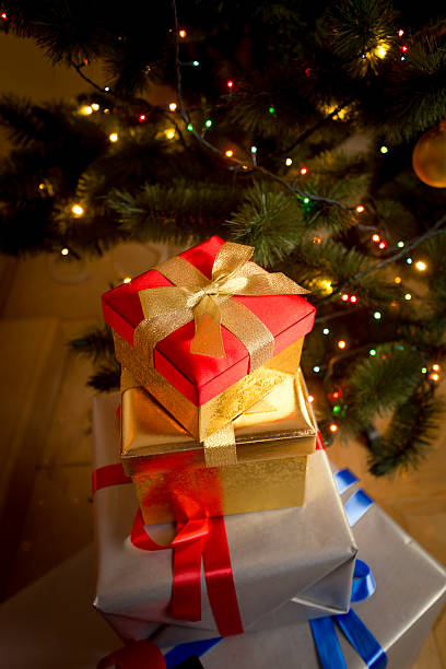 istock Closeup of wrapped gifts in boxes under Christmas tree 493211022