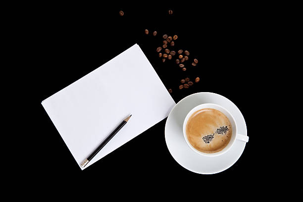 istock cup of coffee and white sheet on a black background 493211328
