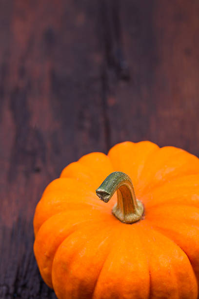 istock Pumpkin on a wooden table 493212070