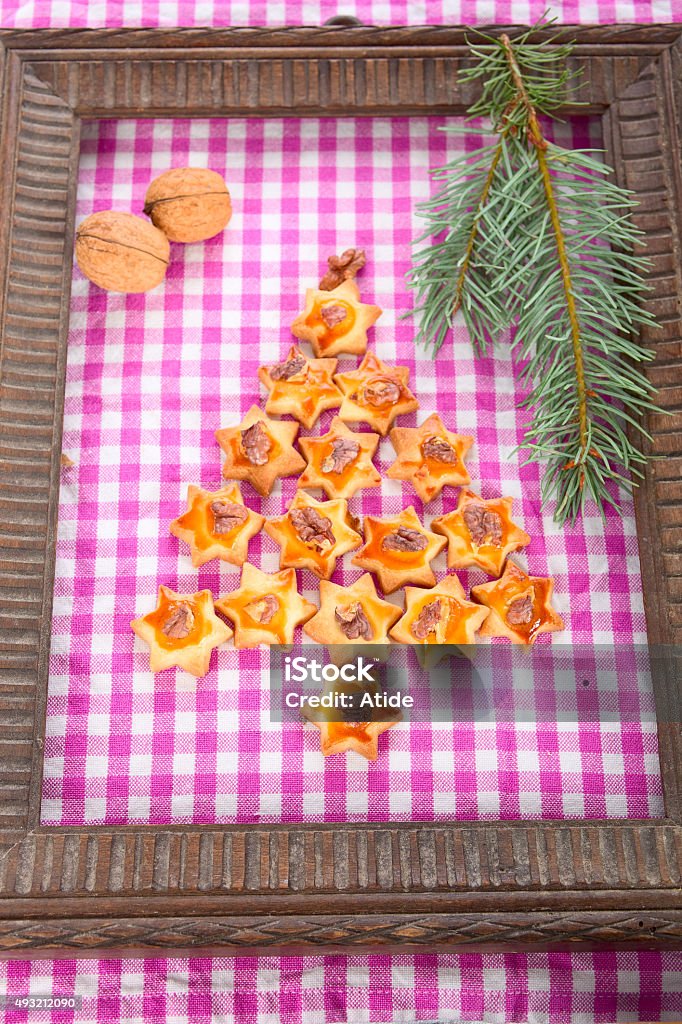 Christmas three cookies Christmas tree from the walnut cookies on the checkered background. 2015 Stock Photo