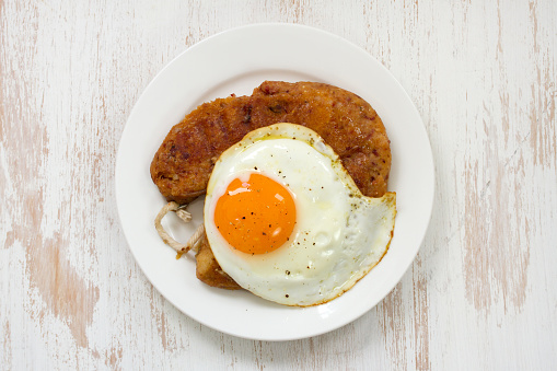 fried alheira with egg on plate