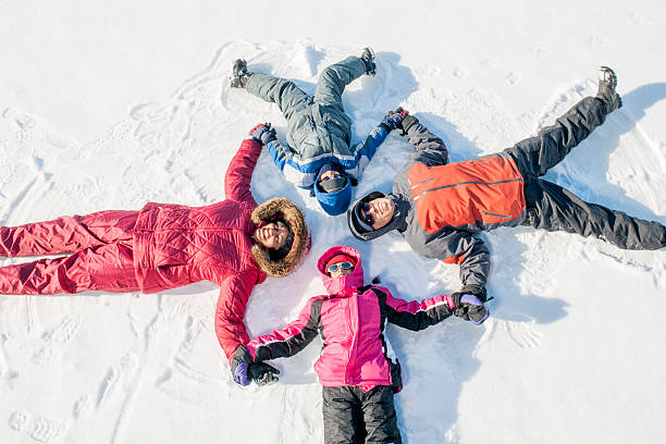 istock Family Lying in a Circle in the Snow 493213006