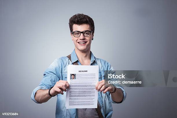 Young Man With Resume Stock Photo - Download Image Now - Résumé, Holding, Teenager