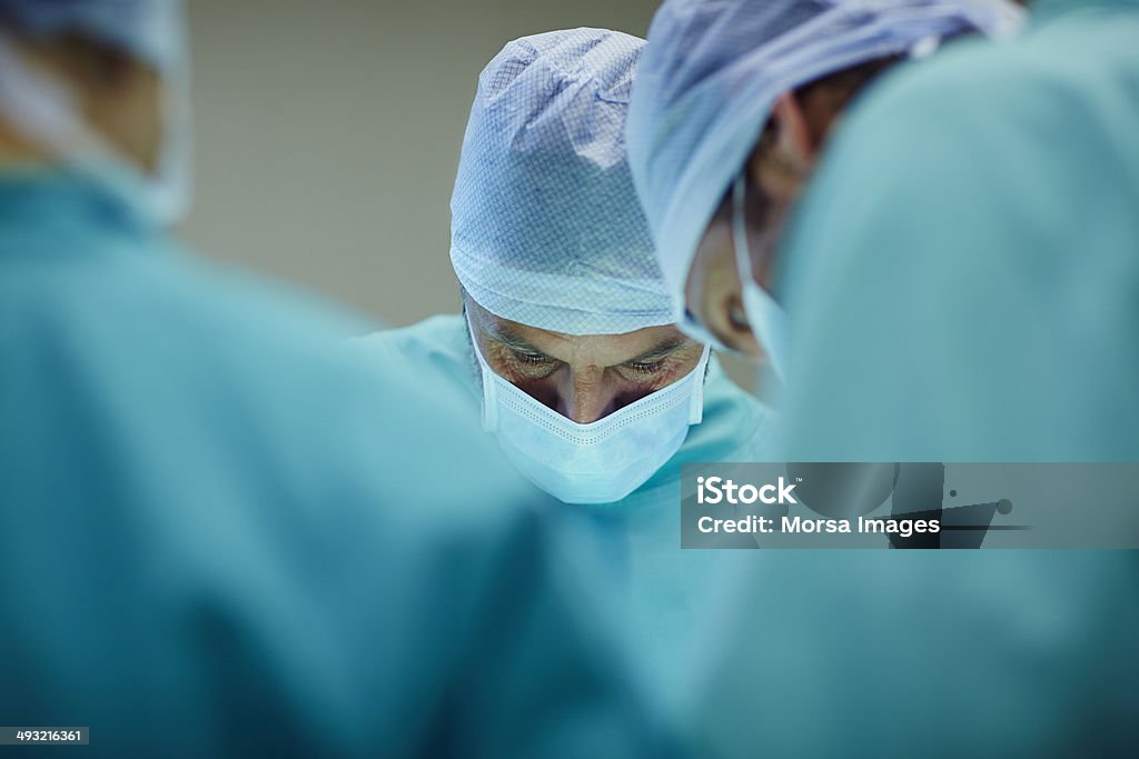 Surgeons working in operating room Male surgeons working in operating room at hospital Surgery Stock Photo