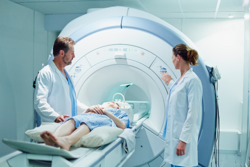 Doctors preparing patient for MRI scan photo