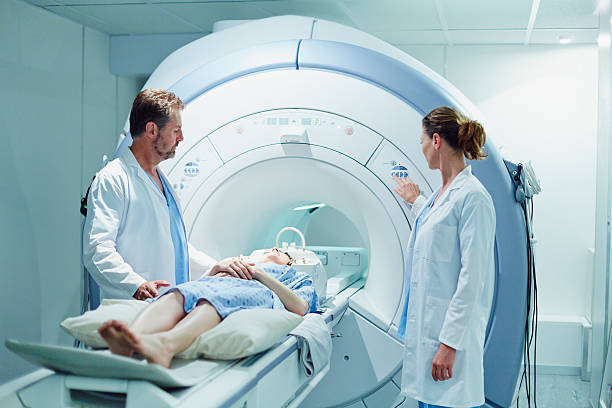 Doctors preparing patient for MRI scan stock photo