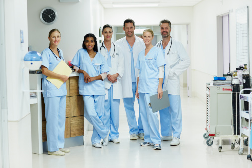 Portrait of confident doctors and nurses standing together in hospital