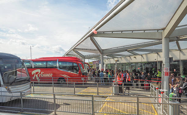 Coach Station in Stansted Stansted, UK - September 24, 2015: The London Stansted airport coach station links the airport to London and all major cities in England and is used by thousands of travellers daily coach bus stock pictures, royalty-free photos & images