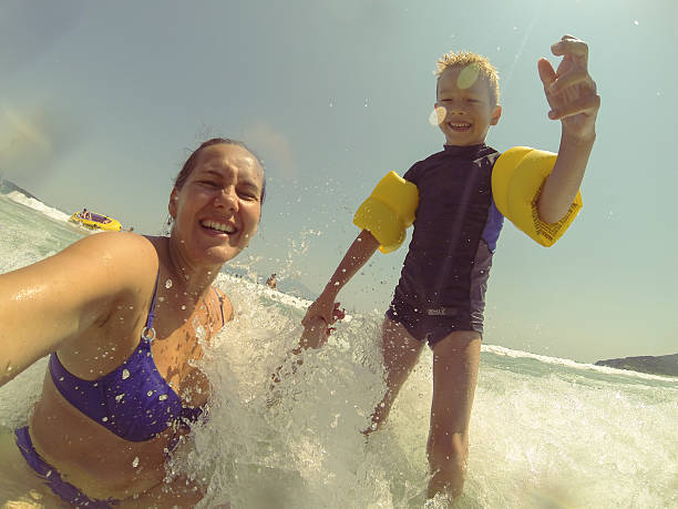 istock Mother and son taking selfie in the sea 493217254