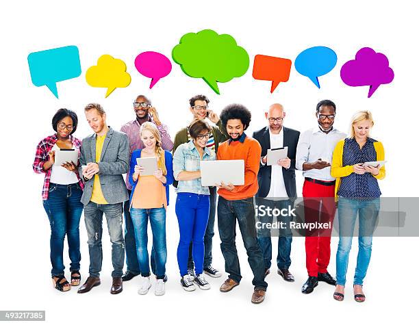 Group Of Multiethnic Group Of People Holding Electronic Devices Stock Photo - Download Image Now