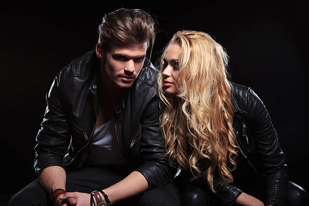 istock young couple sitting next to each other 493217477
