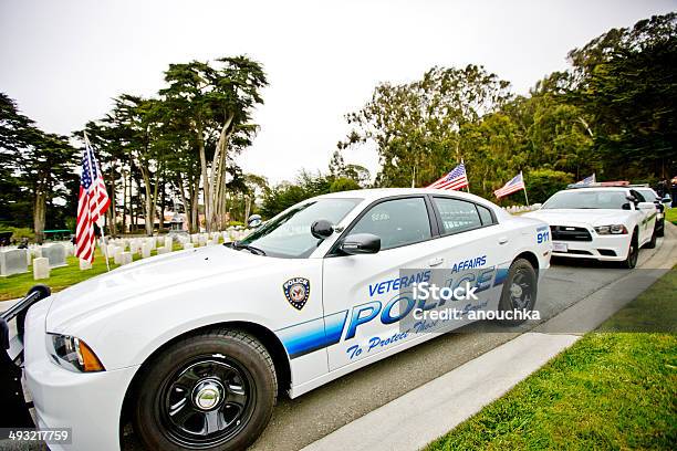 Us Memorial Day Ceremony Police Cars Parked On The Cemetery Stock Photo - Download Image Now