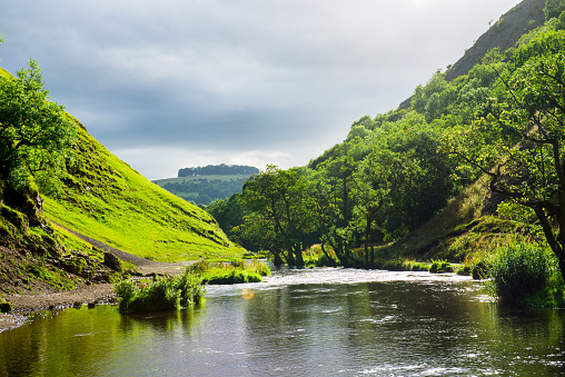 Beautiful View on the Green Hills and River Dove and Stepping Stones at Dovedale in the English Peak District National Park