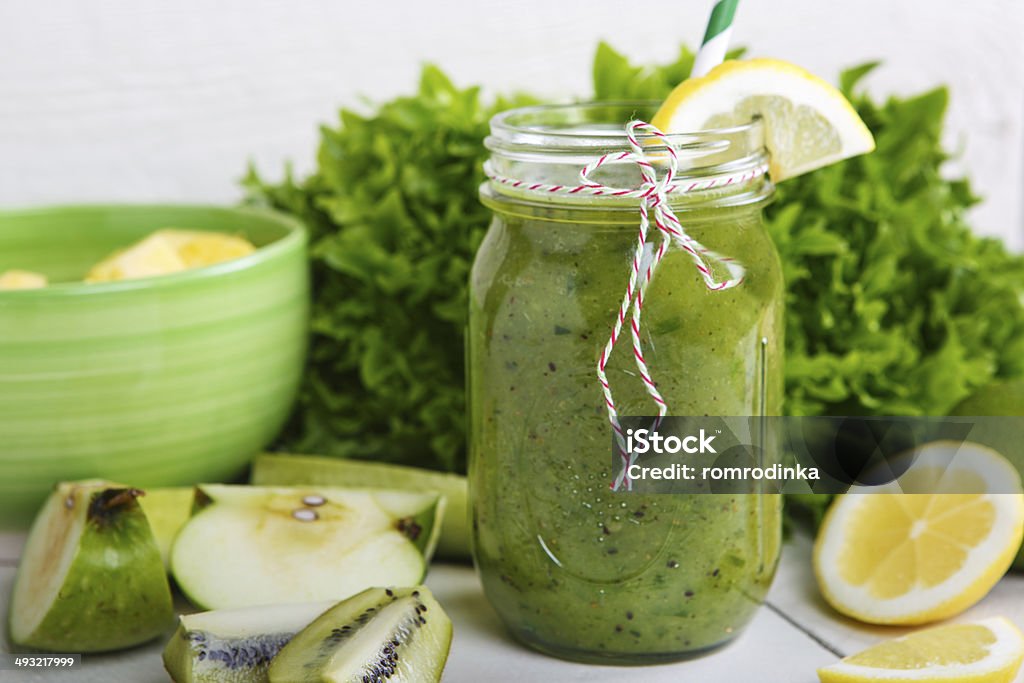 Fresh organic green smoothie with salad, apple, cucumber, pineap Fresh organic green smoothie with salad, apple, cucumber, pineapple and lemon as healthy drink Apple - Fruit Stock Photo