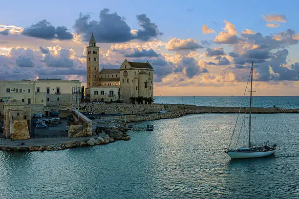 Harbor at sunset: Romanesque cathedral of San NIcola Pellegrino.