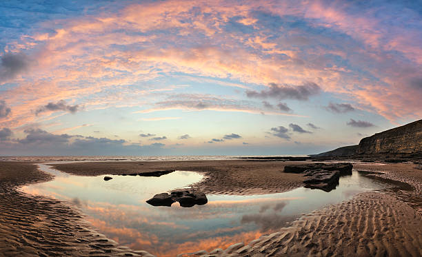 istock Stunning vibrant panorama sunset landscape over Dunraven Bay in 493220372