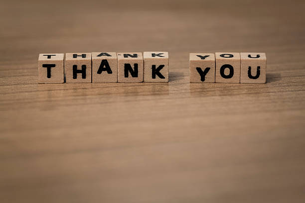 thank you written in wooden cubes on a desk