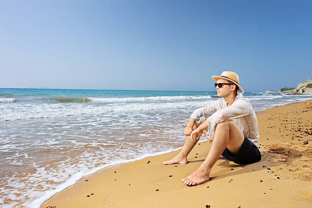 istock Lost male tourist sitting on a beach and thinking 493220997