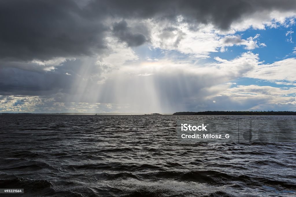 Stormy lake landscape with yachts on water. Lake landscape at storm photographed from yacht. Landscape with yachts on lake. Mazury lake district. 2015 Stock Photo