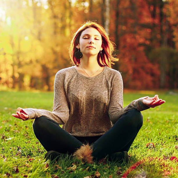 istock Beautiful young girl meditating 493222805
