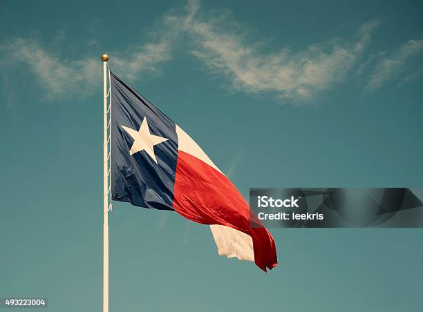 State Flag Of Texas Against Blue Sky Stock Photo - Download Image Now - Texas State Flag, Retro Style, Texas