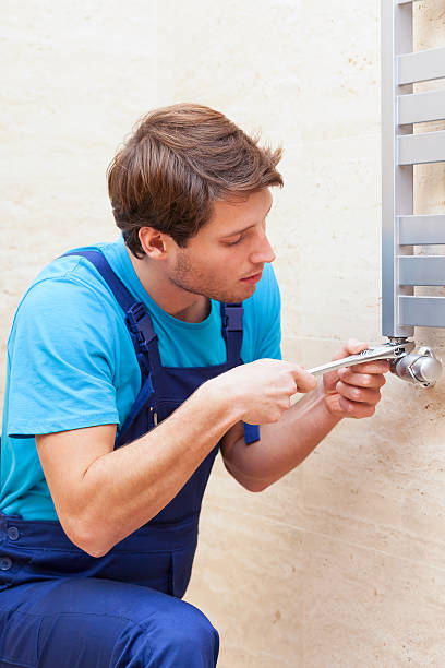 istock Young repairman fixing heater 493223179