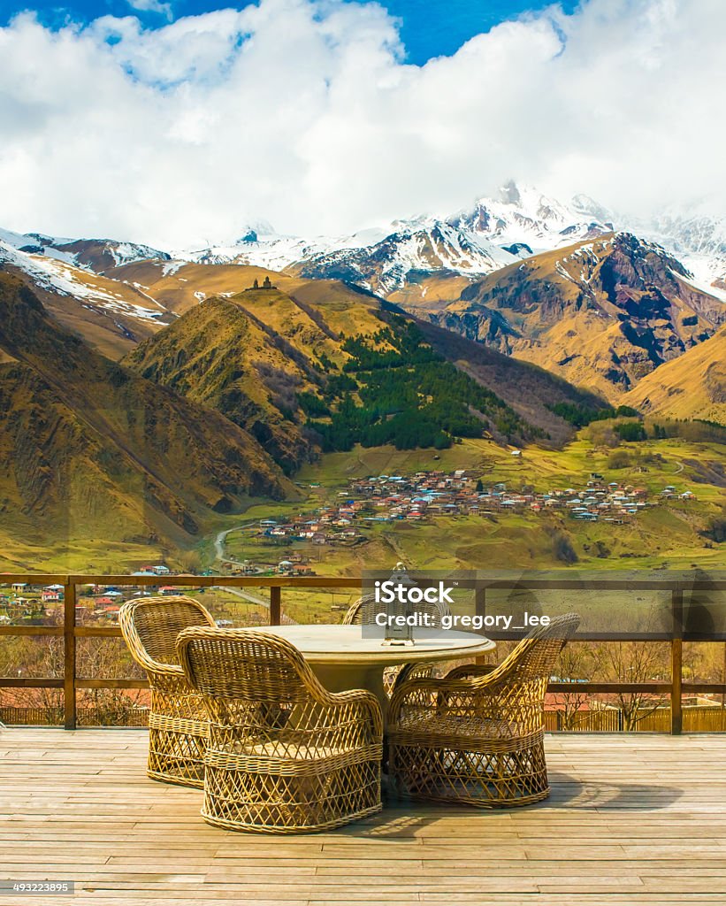 Mountains Rattan chairs and table on terrace with beautiful mountain view Autumn Stock Photo