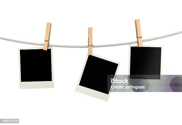 Three Polaroid Pictures Hanging On A Clothesline With Pins Stock