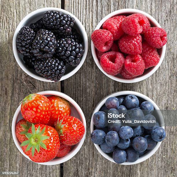 Strawberries Blueberries Blackberries And Raspberries In Bowls Stock Photo - Download Image Now