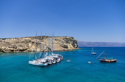 Ano Koufonisi island, Cyclades, Greece - July 22, 2014: Sailing yachts anchored in a gulf
