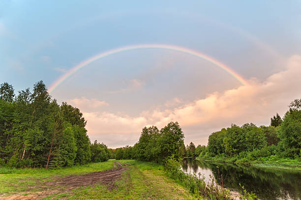 istock Beautiful double rainbow over river with dirty road along 493225185