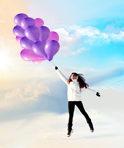 istock happy girl flying on balloons winter 493236584