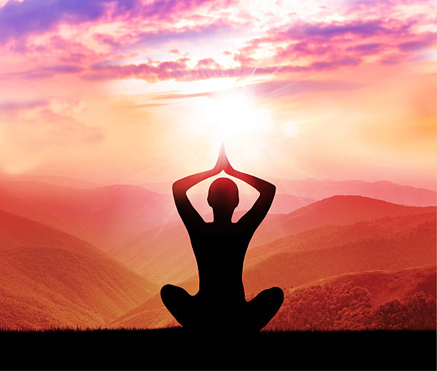 istock Meditation. Silhouette of man in the mountain 493236664