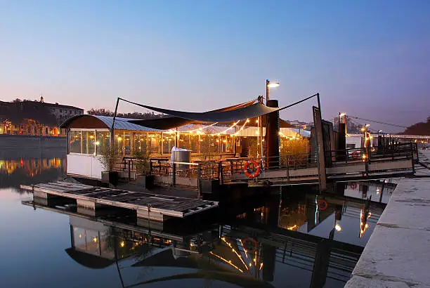 Photo of French restaurant on a river.