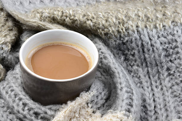 istock Hot chocolate in coffee mug cup with knitted scarf blanked 493239096