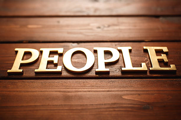 istock Gold text people on wood 493241918