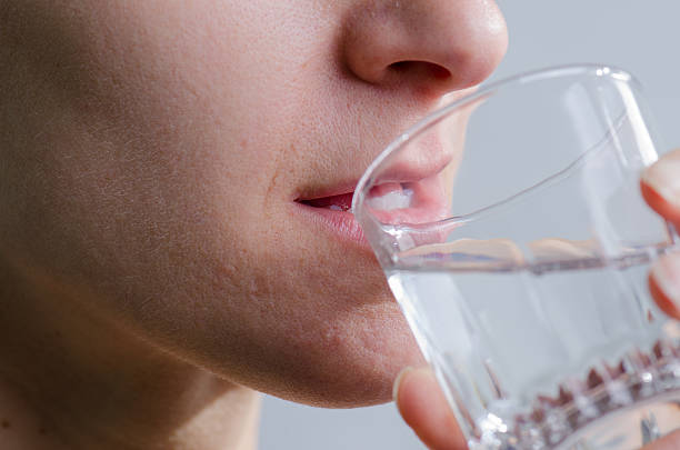 istock Close up woman no makeup drinking water 493245210