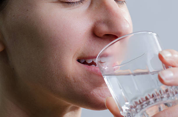 istock Close up woman no makeup drinking water 493245286