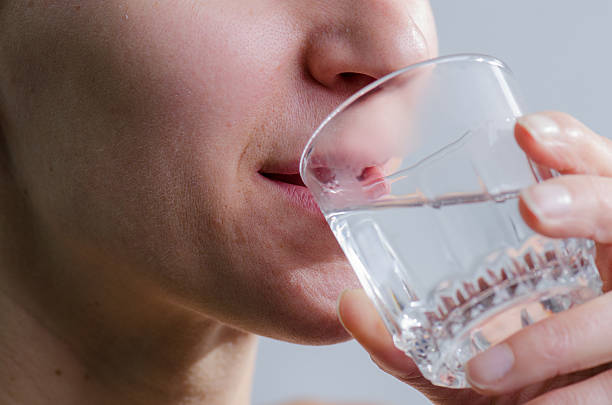 istock Close up woman no makeup drinking water 493245318