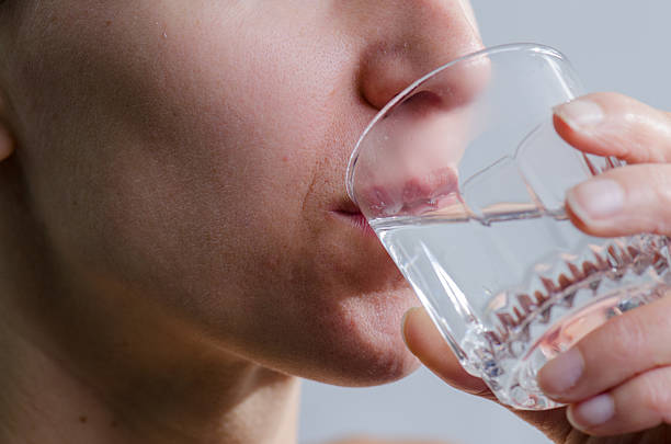 istock Close up woman no makeup drinking water 493245352