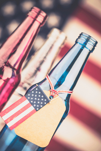 Red, white and blue beer bottles with blank gift tag